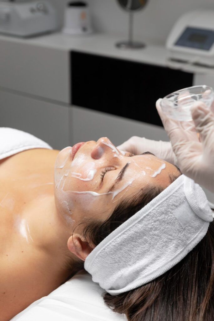 A professional esthetician performing an oxygen facial treatment, highlighting the expert techniques used to maximize the benefits of oxygen facials.